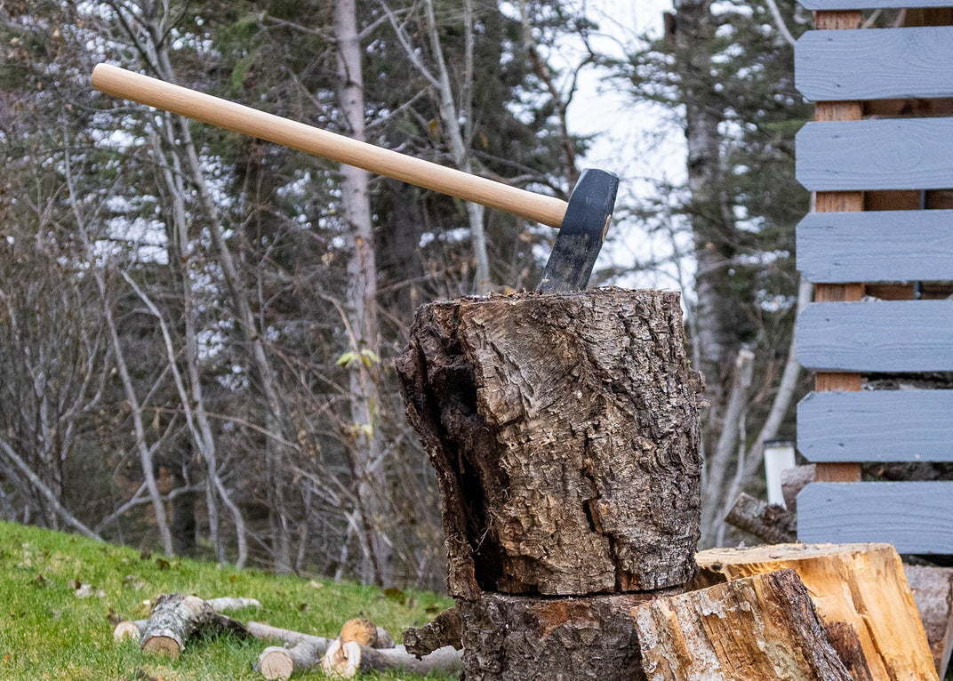 Warwood Tool Wood Splitting Maul embedded in a split log