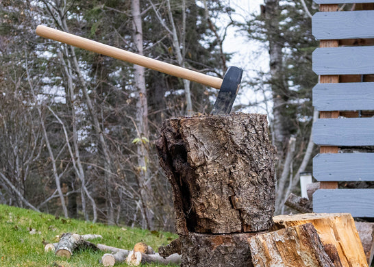 Warwood Tool Wood Splitting Maul embedded in a split log